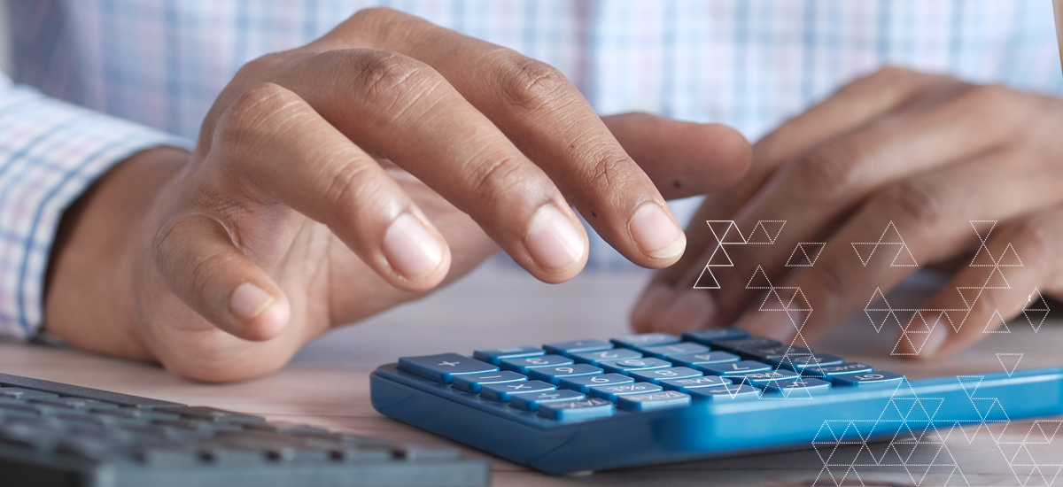 Hands pressing numerical keys on calculator